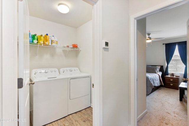 washroom featuring light hardwood / wood-style floors, ceiling fan, and washing machine and clothes dryer