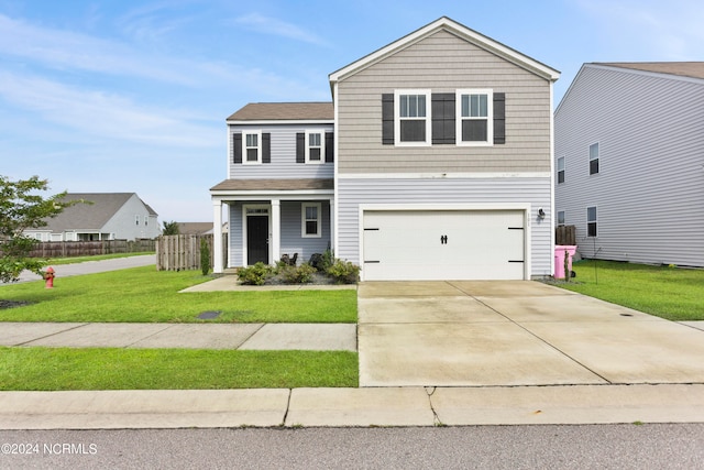 front of property featuring a garage and a front lawn