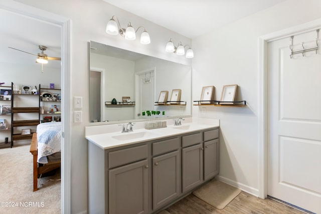 bathroom with ceiling fan, wood-type flooring, and vanity