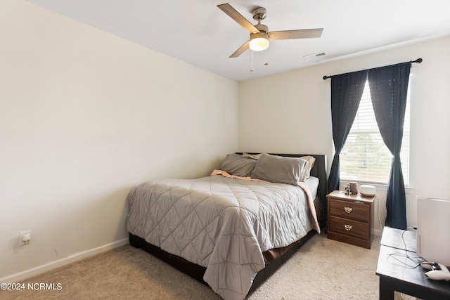 bedroom featuring ceiling fan and light carpet