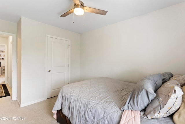 bedroom featuring light carpet and ceiling fan