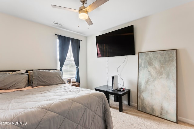 bedroom featuring light carpet and ceiling fan