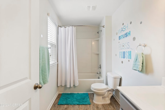 full bathroom with vanity, hardwood / wood-style flooring, toilet, and shower / tub combo with curtain