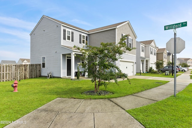 view of front facade featuring a garage and a front yard