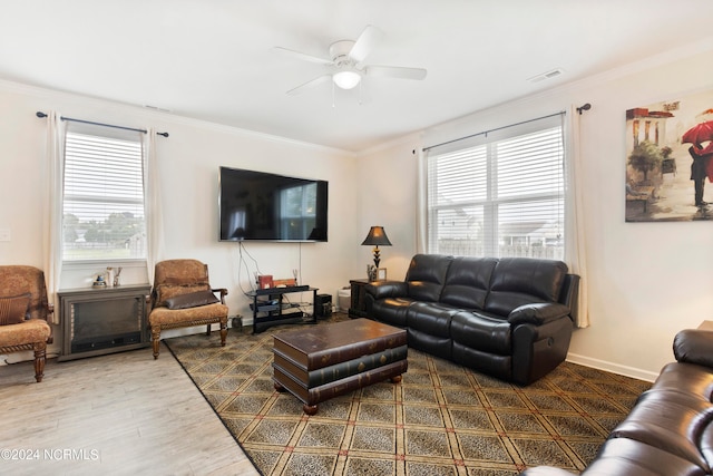 living room featuring crown molding, wood-type flooring, a healthy amount of sunlight, and ceiling fan