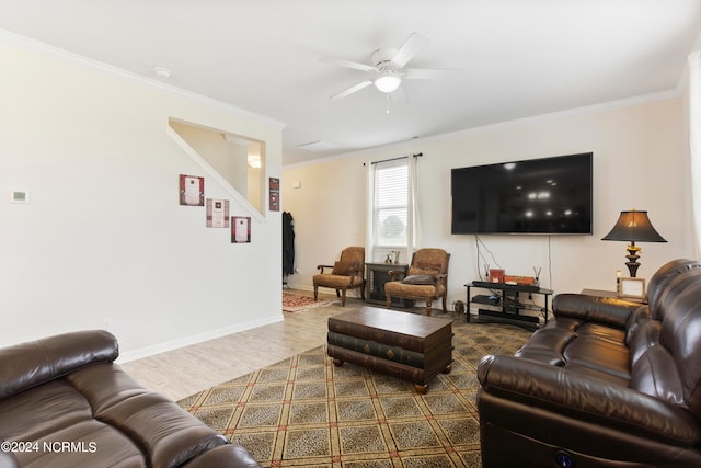 living room featuring hardwood / wood-style floors, ceiling fan, and ornamental molding