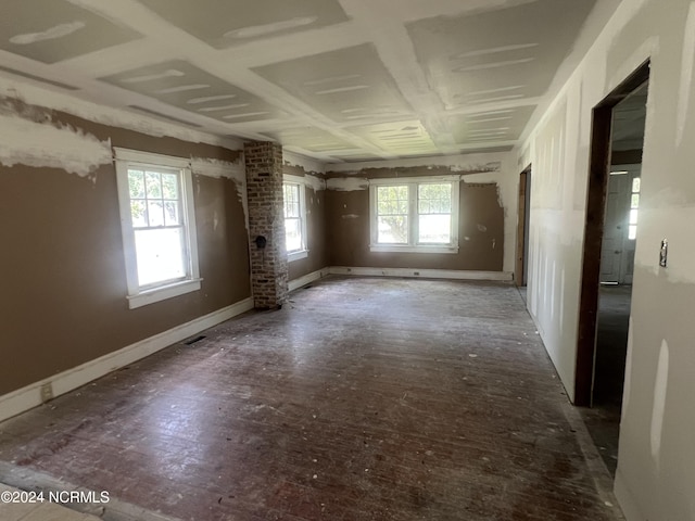 spare room featuring a wealth of natural light, visible vents, and baseboards