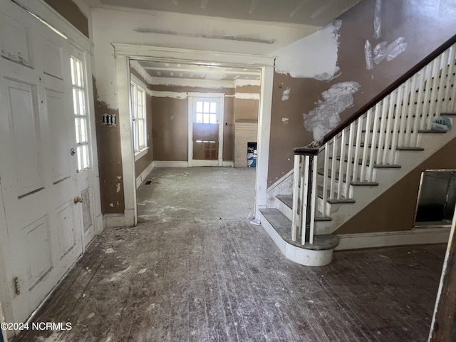 entryway featuring stairs and baseboards