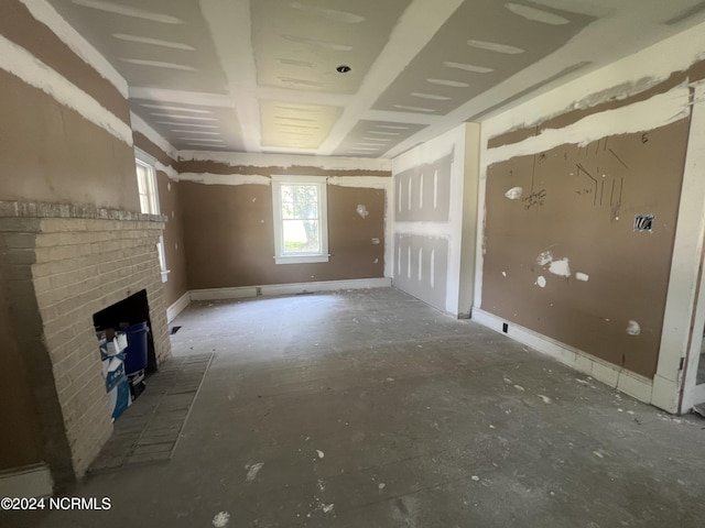 unfurnished living room with a brick fireplace