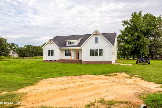 modern farmhouse style home with a front lawn