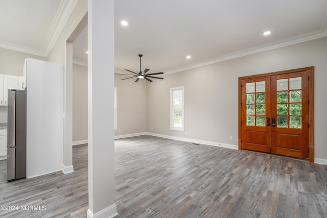 unfurnished living room featuring french doors, crown molding, ceiling fan, and light hardwood / wood-style flooring