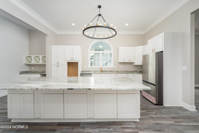 kitchen featuring white cabinetry, light stone counters, stainless steel appliances, and a spacious island