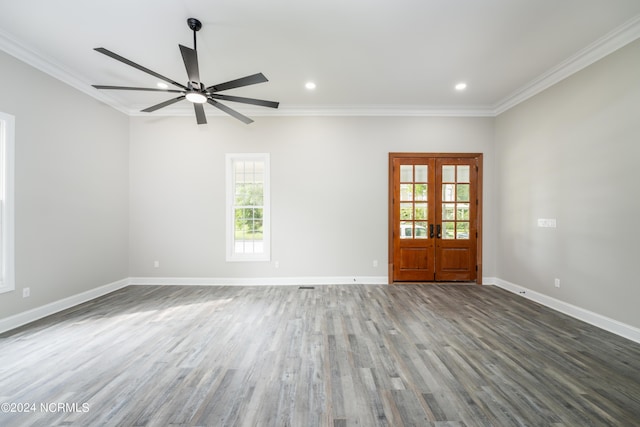 empty room with ornamental molding, dark wood-type flooring, ceiling fan, and french doors