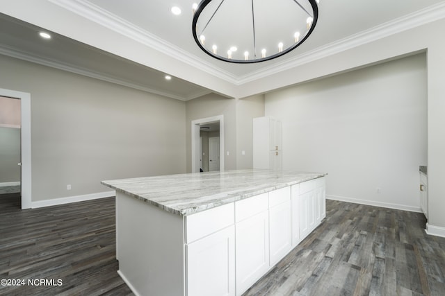 kitchen featuring white cabinetry, light stone counters, dark hardwood / wood-style flooring, and ornamental molding