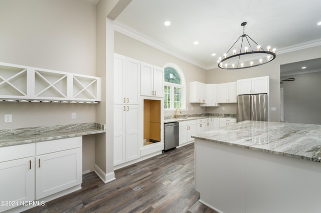 kitchen featuring stainless steel appliances, pendant lighting, and white cabinets