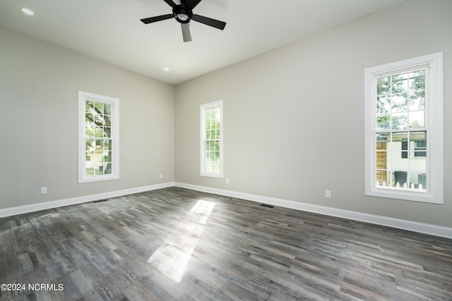 empty room with ceiling fan and dark hardwood / wood-style floors