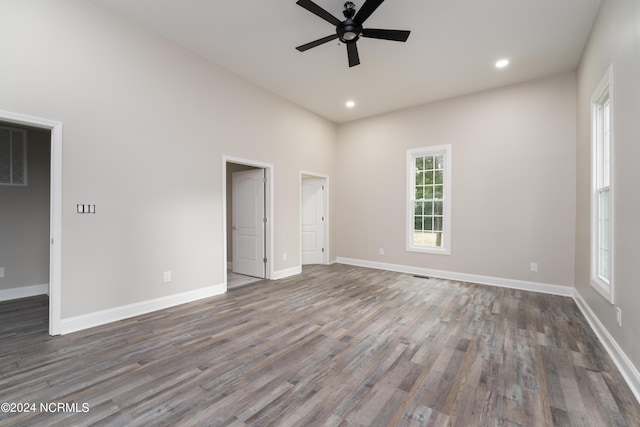 spare room featuring dark wood-type flooring and ceiling fan