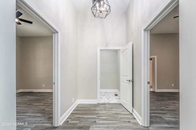 hall featuring hardwood / wood-style floors and a chandelier