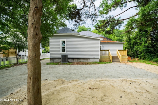 view of home's exterior featuring a wooden deck and central AC