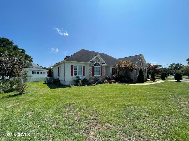 ranch-style house with a front lawn