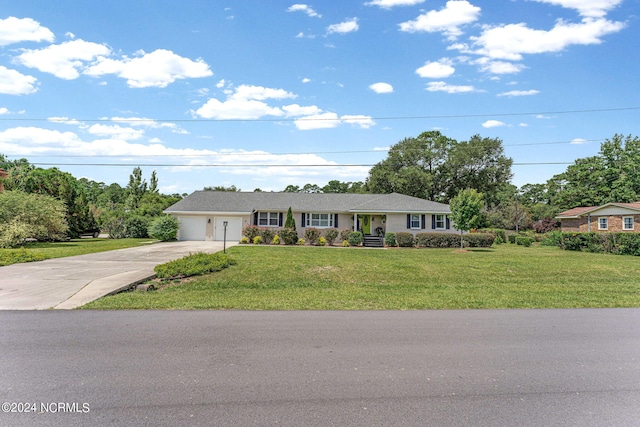 ranch-style house with a garage and a front lawn