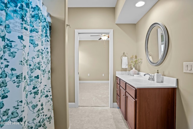 bathroom featuring a shower, ceiling fan, and vanity