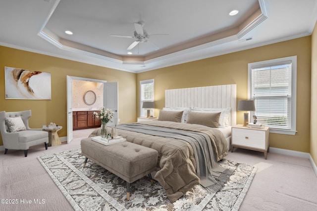 carpeted bedroom featuring ornamental molding, a tray ceiling, and ceiling fan