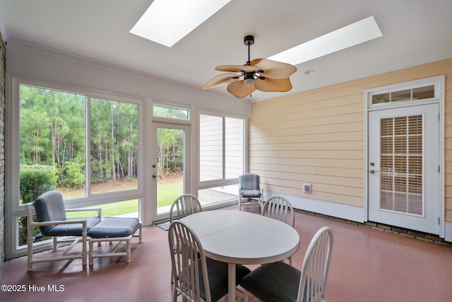 sunroom featuring ceiling fan and a skylight