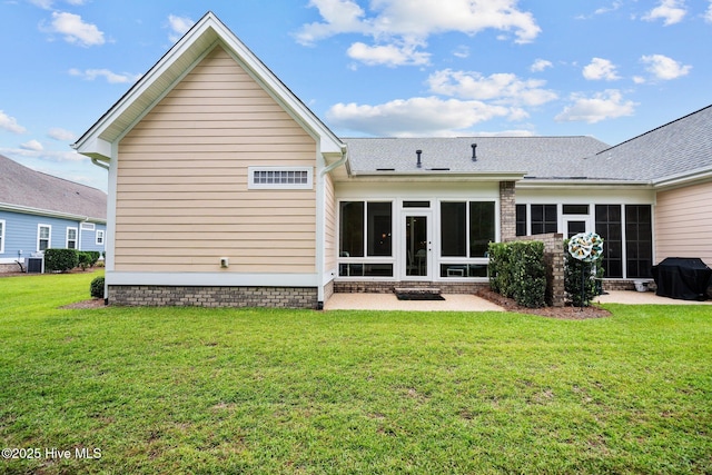 rear view of house with a patio area, french doors, and a yard