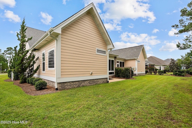 view of side of home featuring a lawn