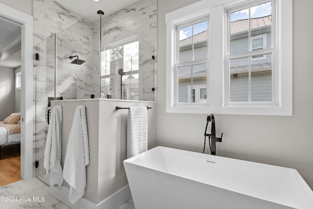 full bath with marble finish floor, ensuite bath, a soaking tub, and a shower stall