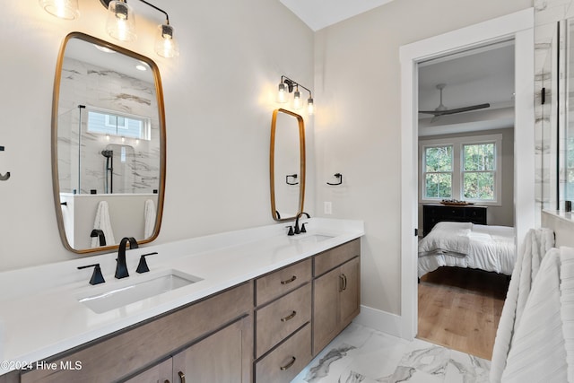 bathroom with double vanity, marble finish floor, a marble finish shower, and a sink