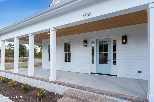 doorway to property with a porch