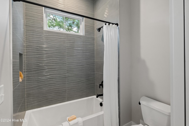 full bathroom featuring toilet and shower / bathtub combination with curtain