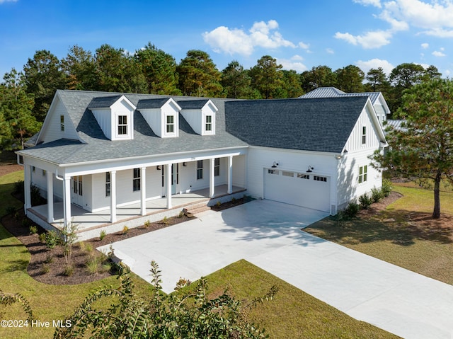 modern inspired farmhouse featuring a porch, concrete driveway, roof with shingles, and an attached garage