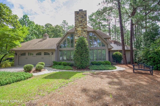 tudor house featuring a garage