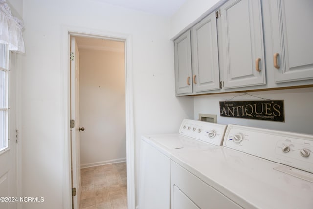 washroom featuring cabinet space and separate washer and dryer