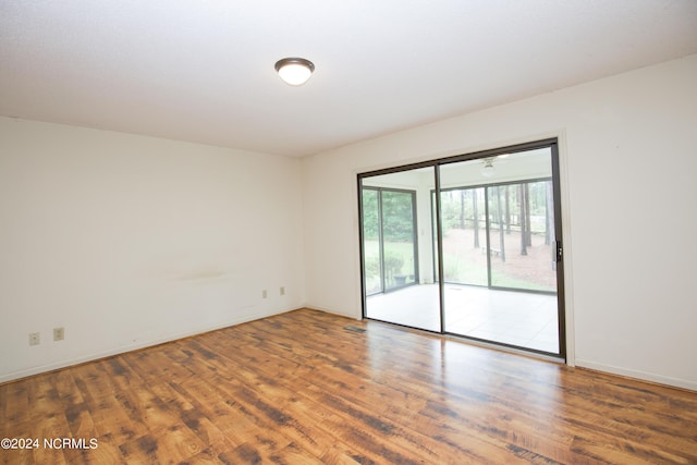 unfurnished room featuring wood finished floors and baseboards