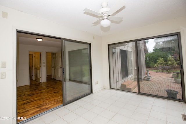 empty room with visible vents, a ceiling fan, and baseboards