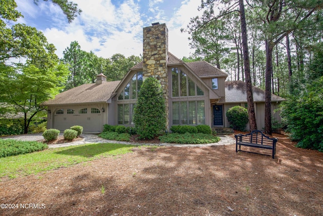 view of front of house featuring a garage and a chimney