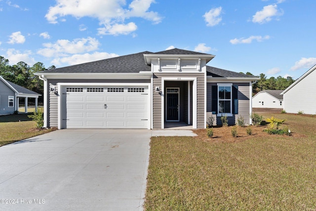 view of front facade featuring a front lawn and a garage