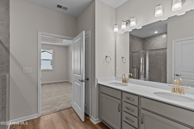 bathroom featuring vanity, hardwood / wood-style flooring, and walk in shower