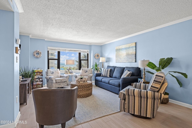 living room featuring ornamental molding, light hardwood / wood-style floors, and a textured ceiling