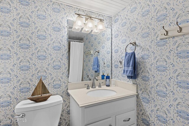 bathroom featuring toilet and vanity