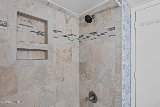 interior details with a tile shower