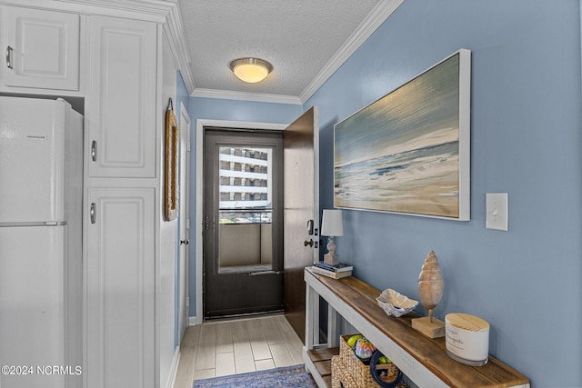 doorway to outside featuring crown molding, a textured ceiling, and light hardwood / wood-style floors