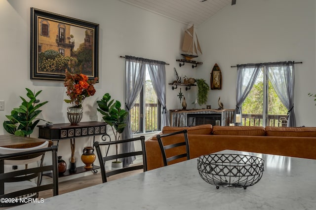 dining area featuring wooden ceiling, hardwood / wood-style flooring, lofted ceiling, and plenty of natural light