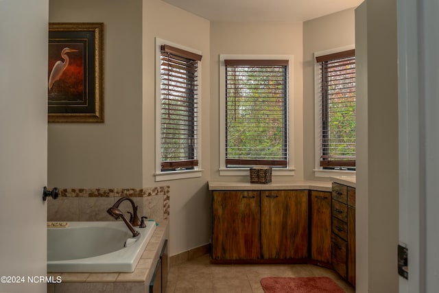 bathroom with tile patterned flooring and a relaxing tiled tub