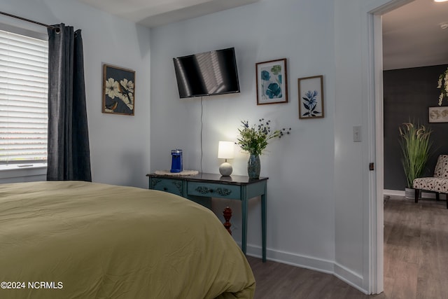 bedroom with dark hardwood / wood-style floors