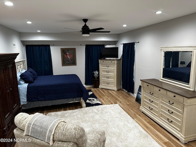 bedroom with ceiling fan and light hardwood / wood-style flooring